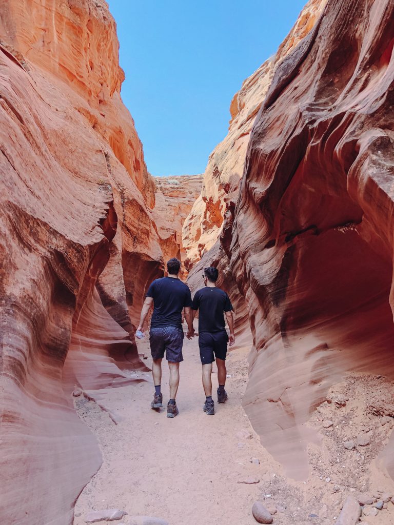 two men walking through a canyon