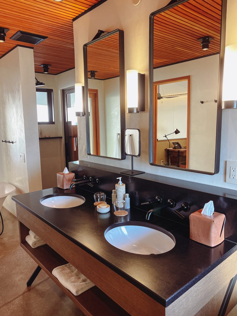 a bathroom with a double sink and mirror