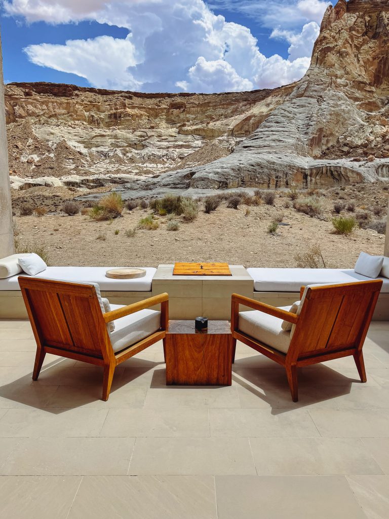 a chair and table outside with a view of a desert