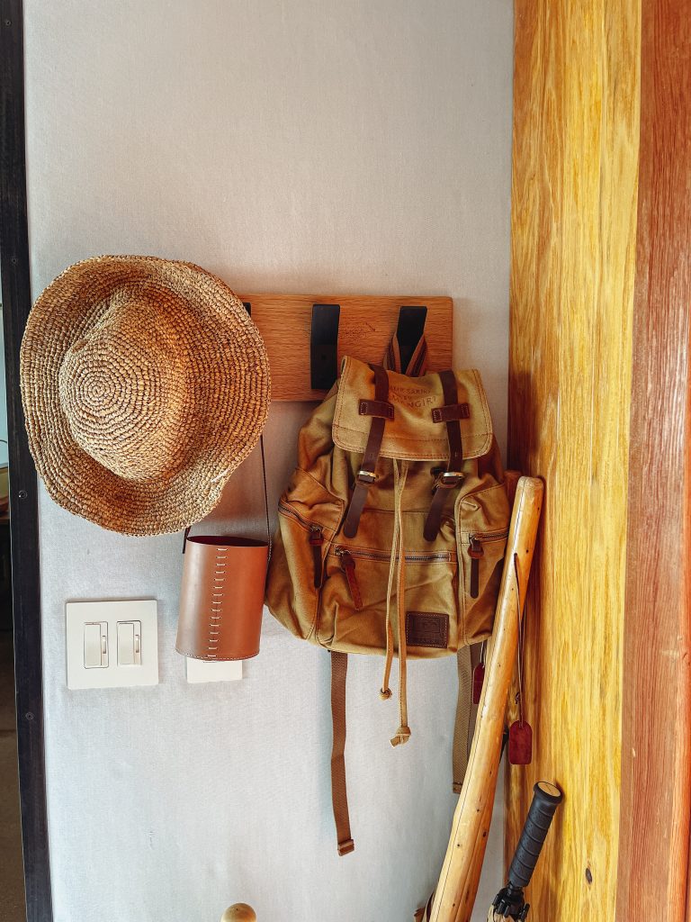 a hat and backpack on a wall