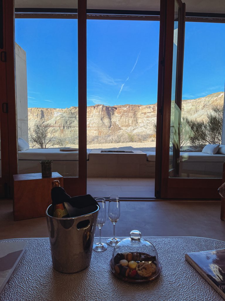 a glass doors with a view of the canyon and a glass table