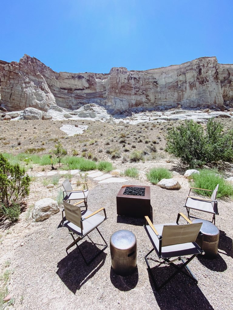 chairs and chairs around a fire pit in a desert