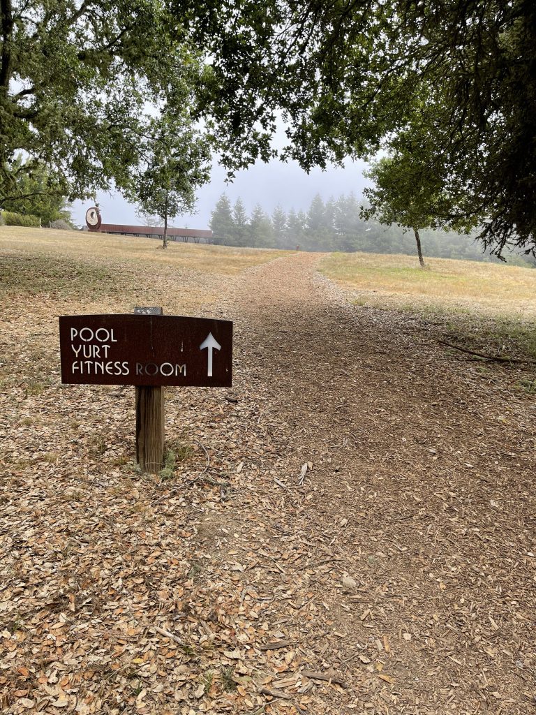 a sign on a dirt path