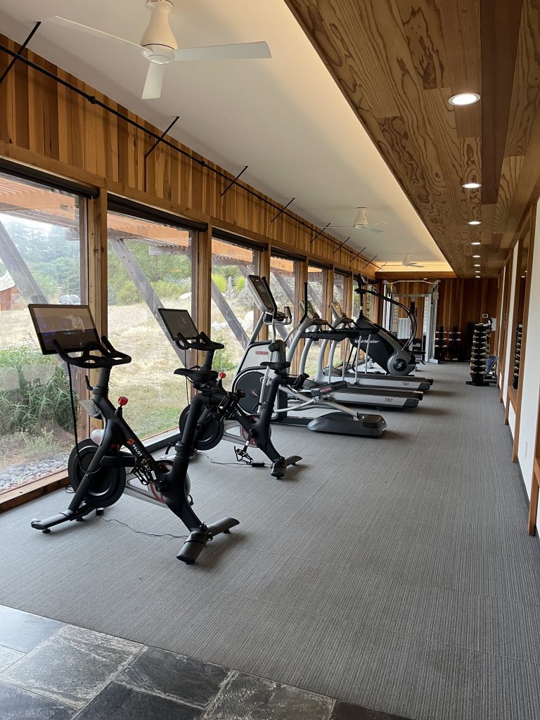 a room with exercise bikes and windows