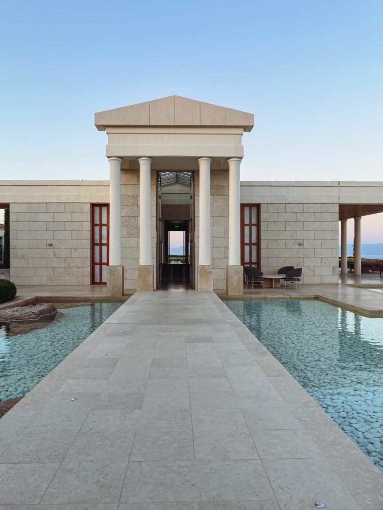 a building with a pool and a stone walkway