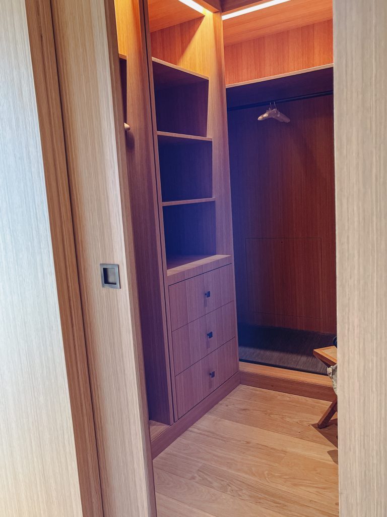 a closet with shelves and a mirror