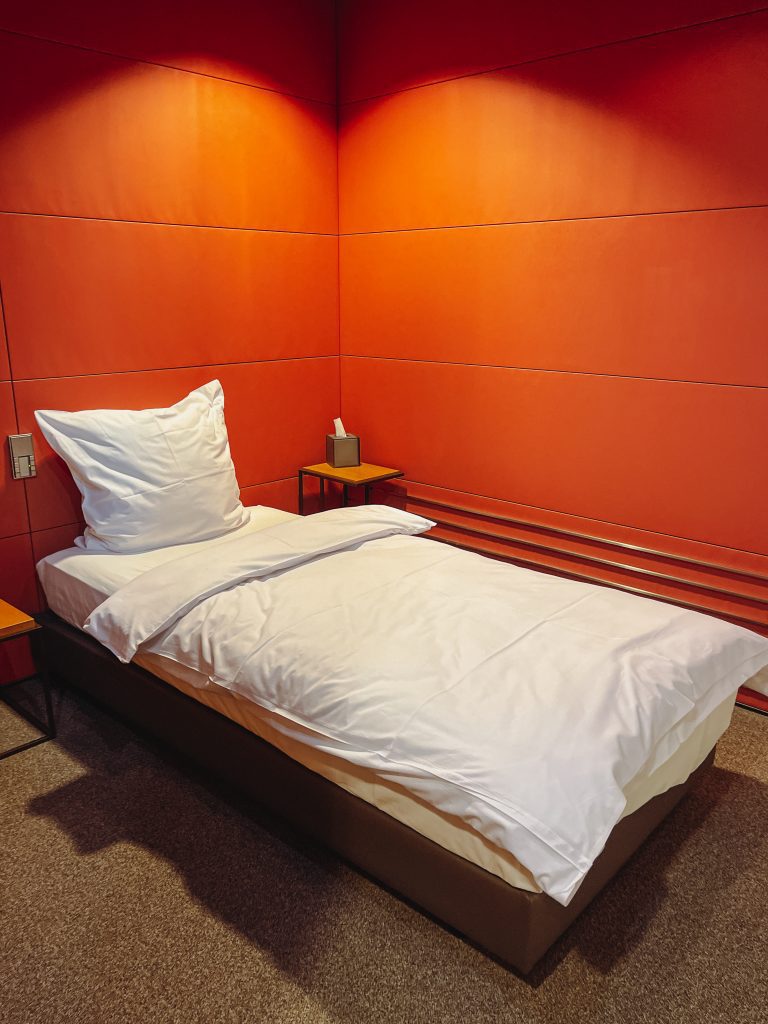 a bed with a white sheet and pillow