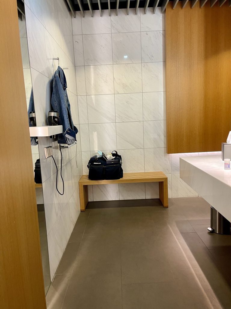 a bathroom with a bench and a sink