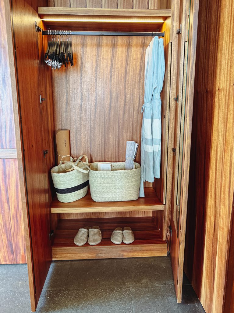 a closet with a towel and baskets