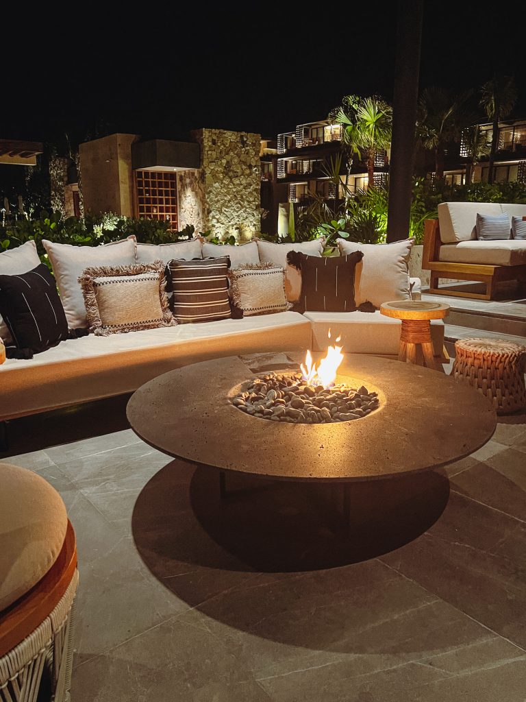 a fire pit with pillows on the outside
