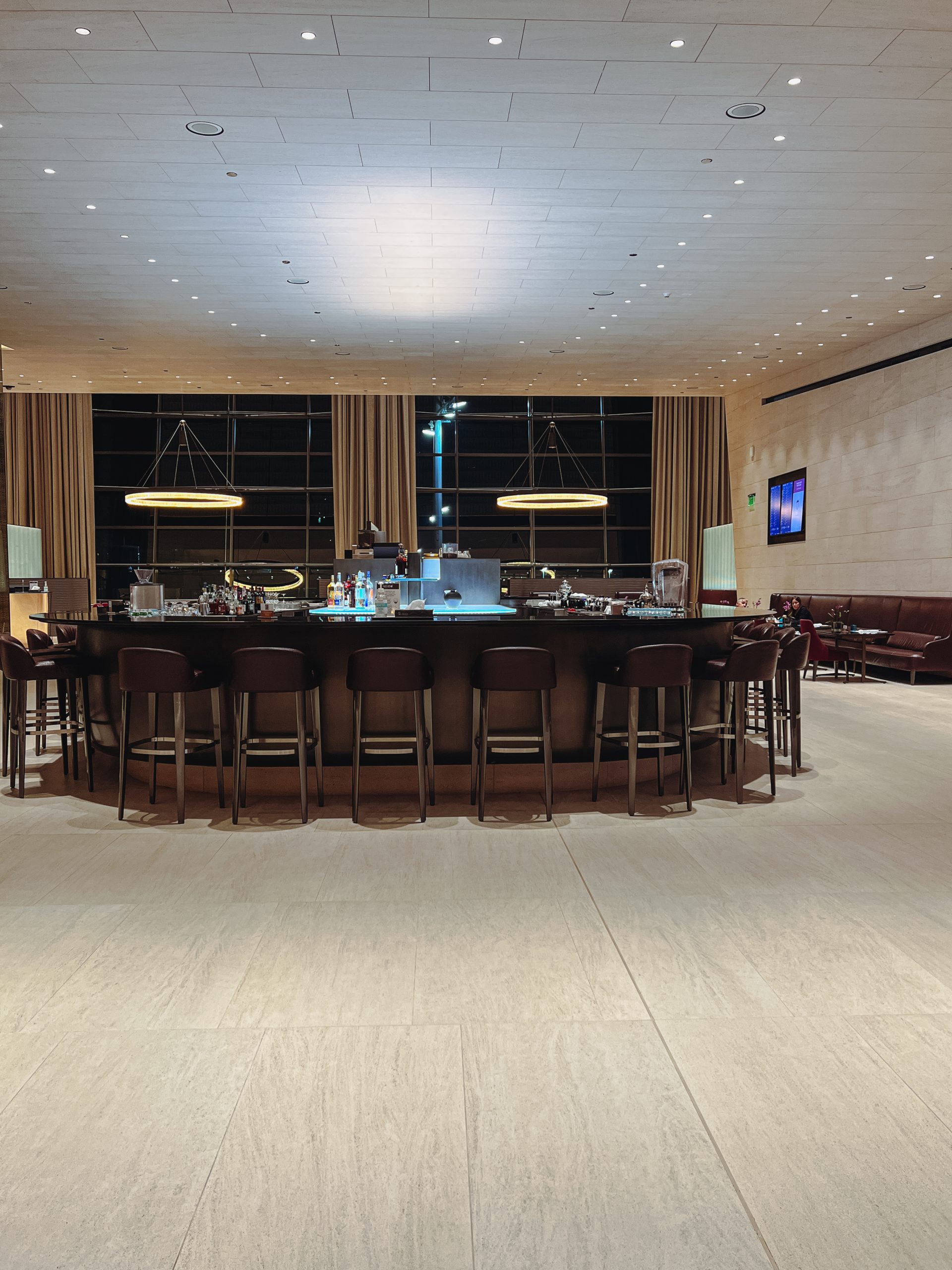 a large bar with chairs in a room