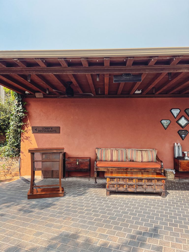 a patio with a bench and a table