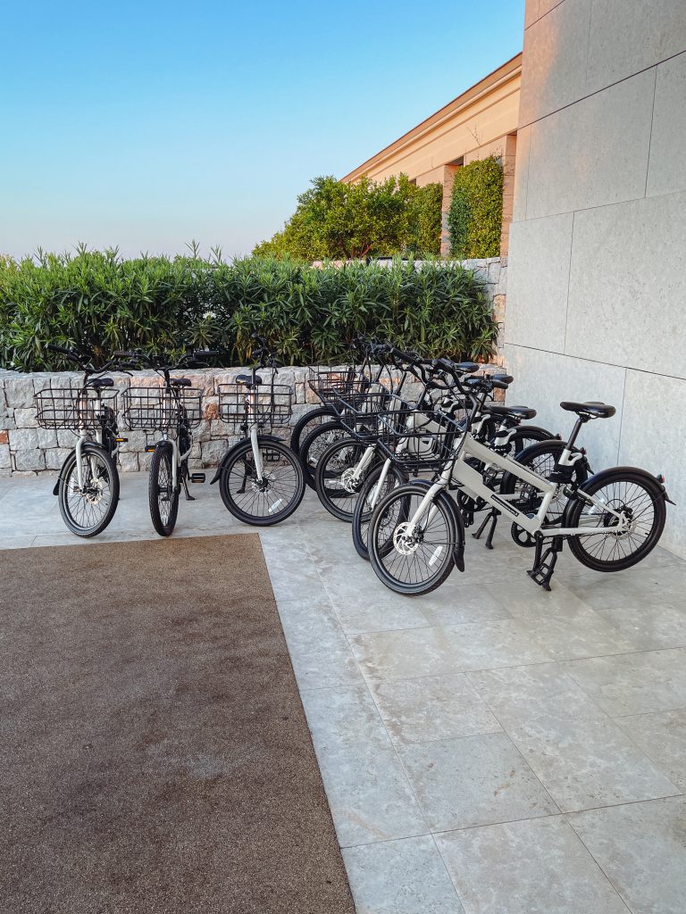 a group of bicycles parked next to a wall