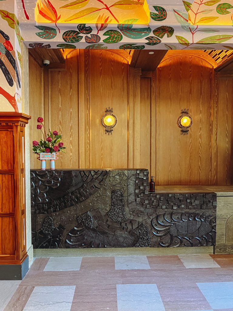 a wood paneled wall with a black counter and flowers