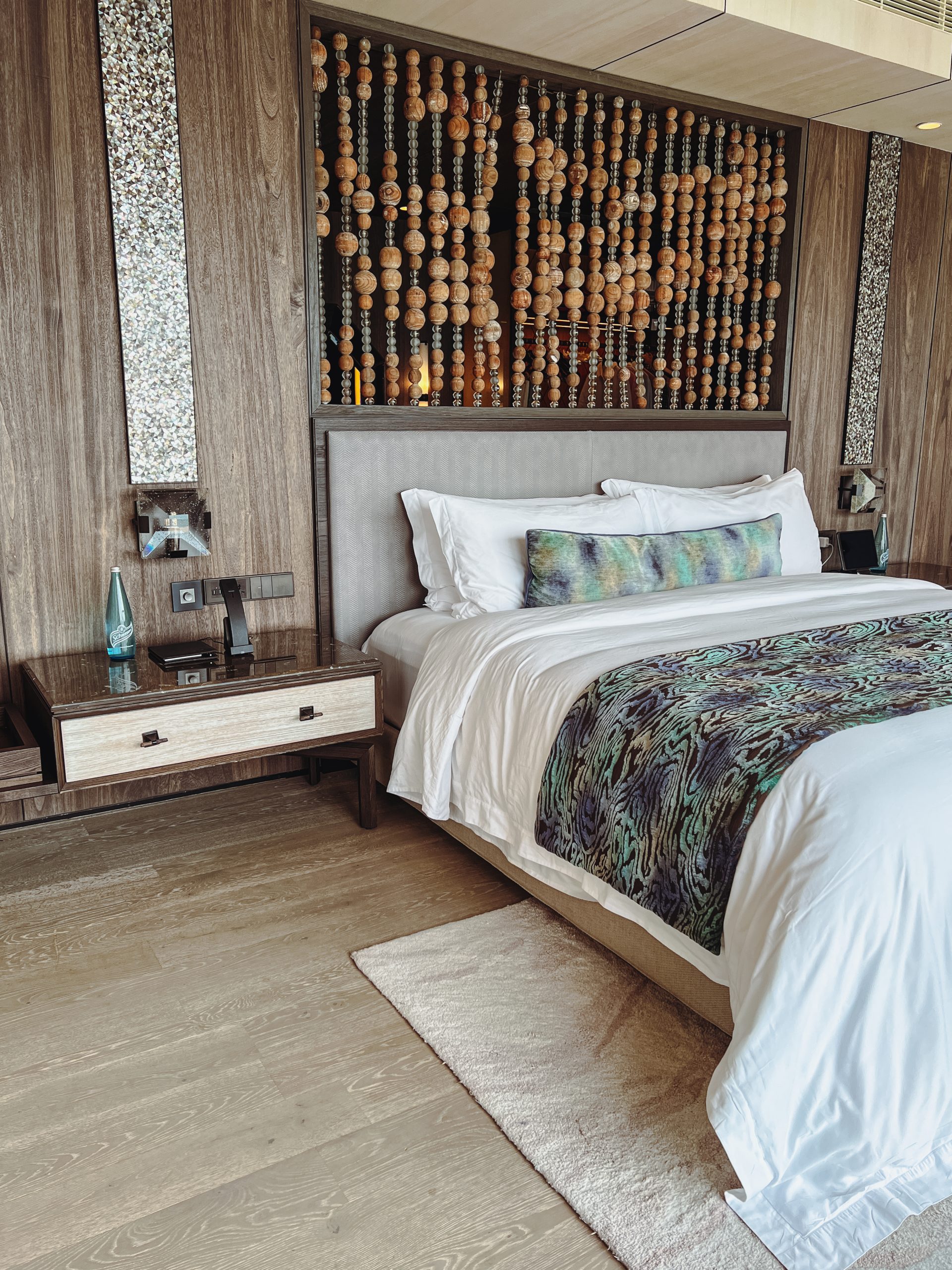 a bed with a wooden headboard and a nightstand