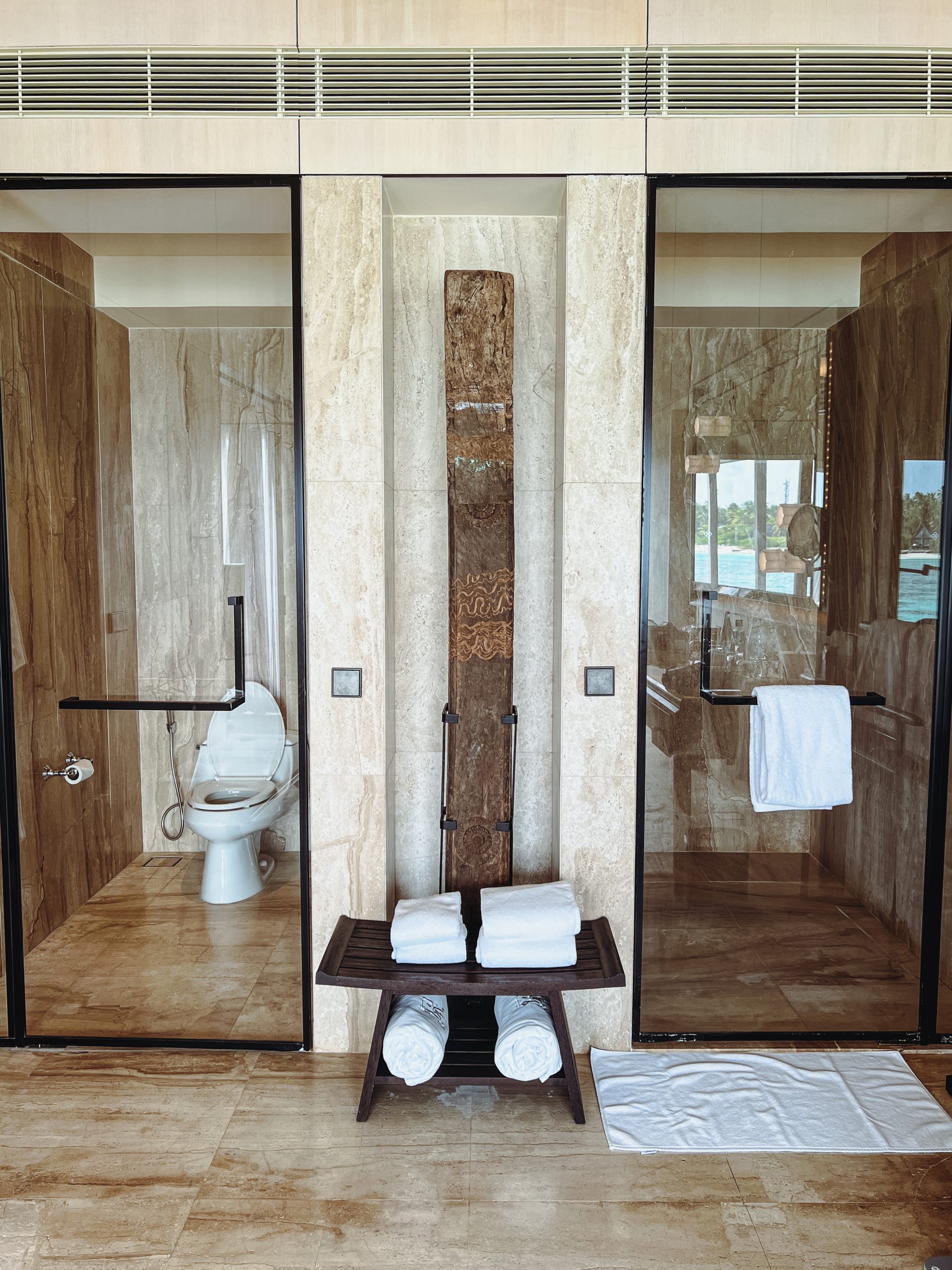 a bathroom with glass doors and a toilet