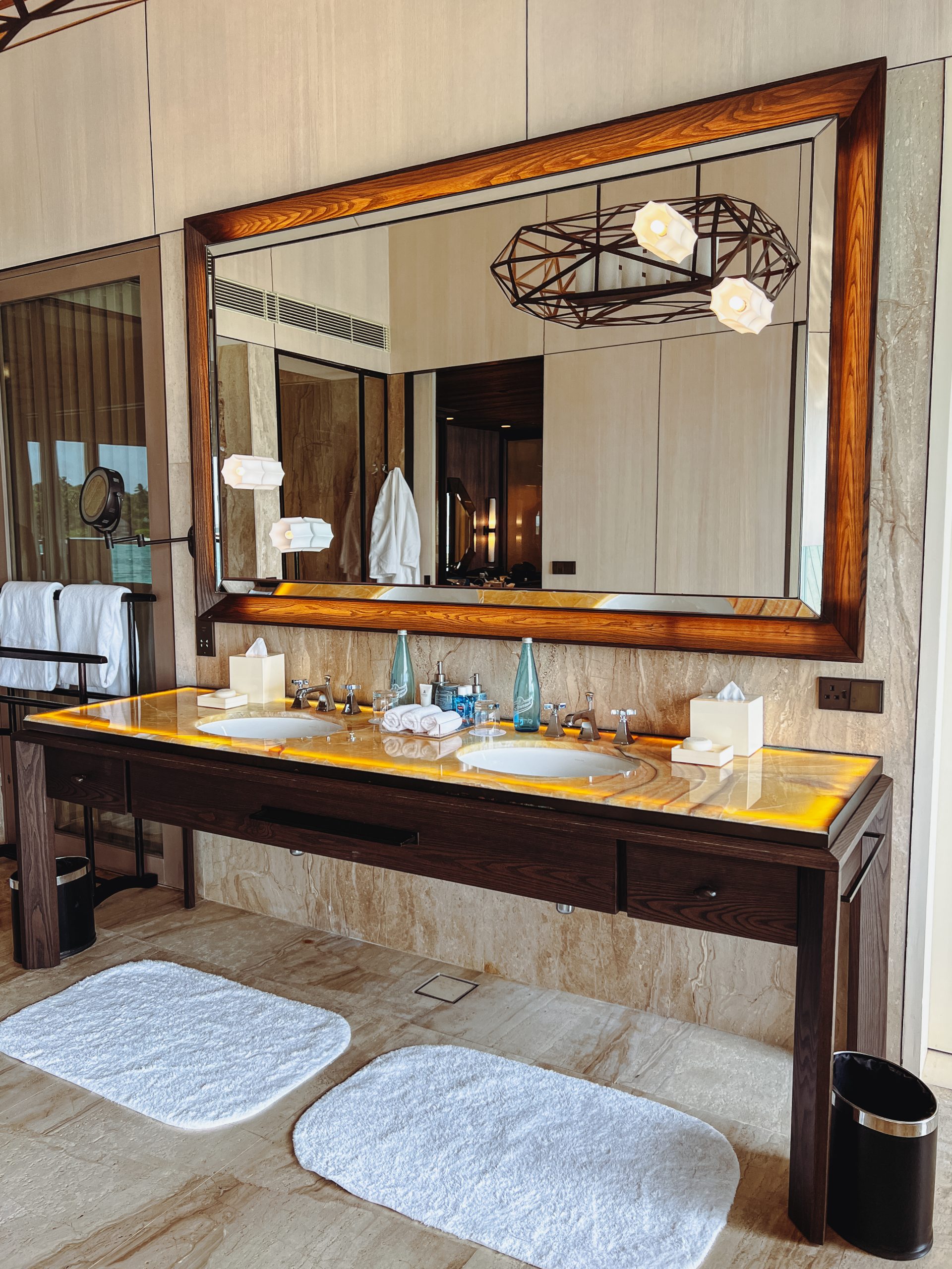 a bathroom with a large mirror and a large vanity