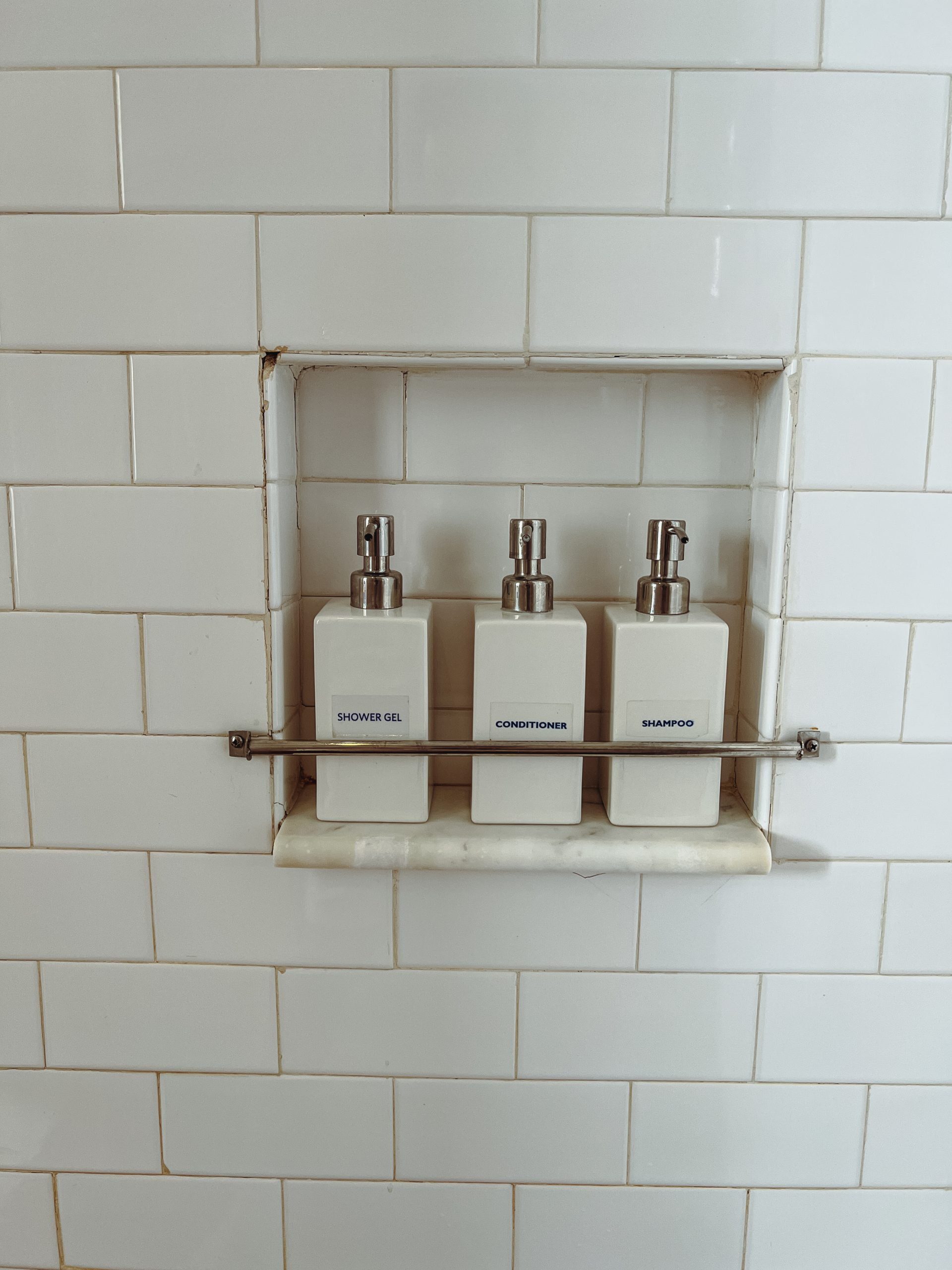 a group of soap dispensers on a shelf