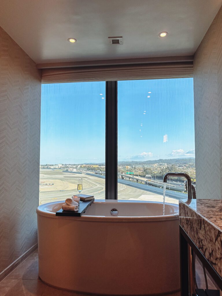 a bathroom with a tub and a window