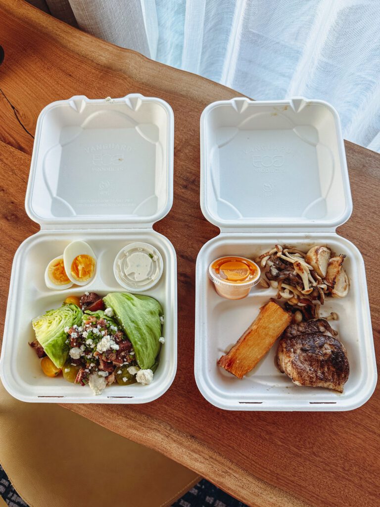 two styrofoam boxes with food on a table
