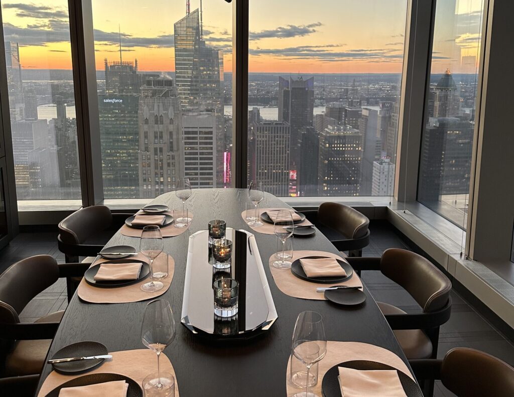 a table set for a dinner with a view of a city