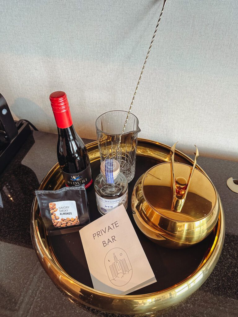 a tray with a bottle of wine and a bowl of food