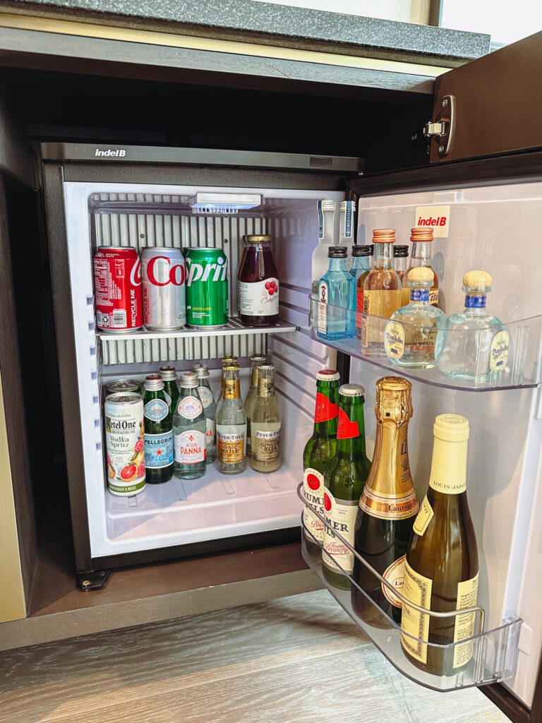 a mini fridge full of bottles of alcohol