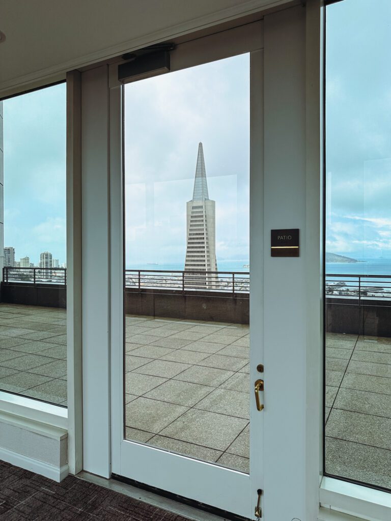 a glass door with a tall building seen through it