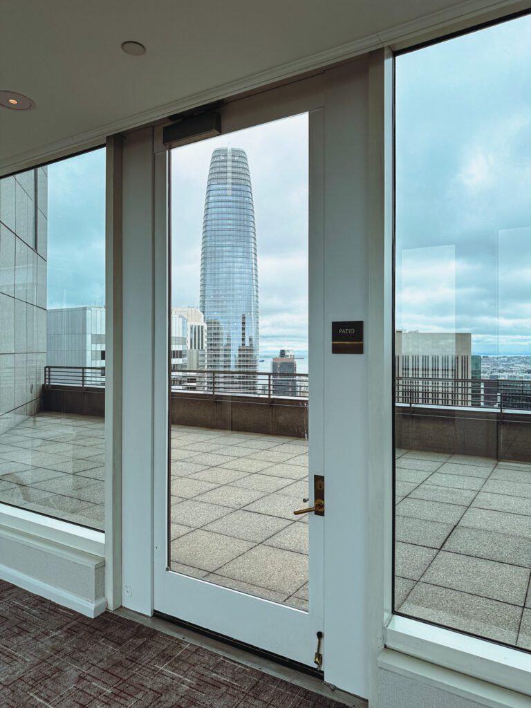 a glass door with a view of a city