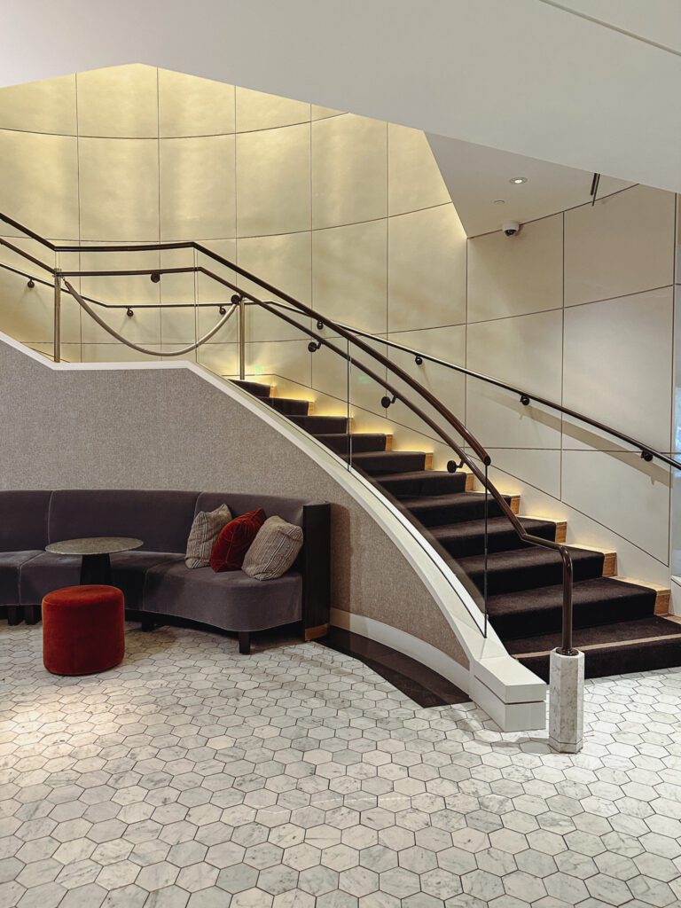 a staircase with a couch and a round table