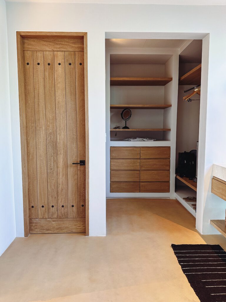 a closet with shelves and a door