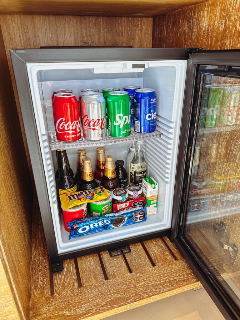 a mini fridge with drinks and snacks