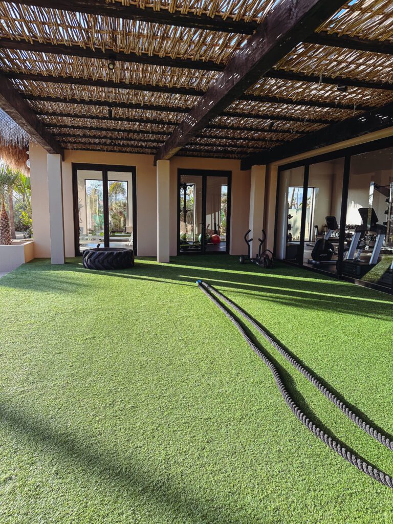 a gym with exercise equipment on the ground