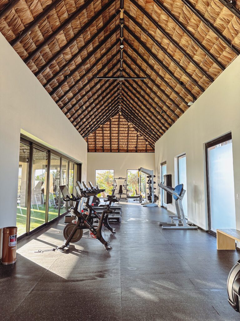 a room with exercise bikes and a roof