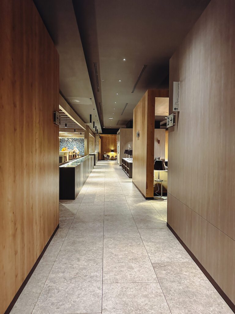 a hallway with wood walls and a counter