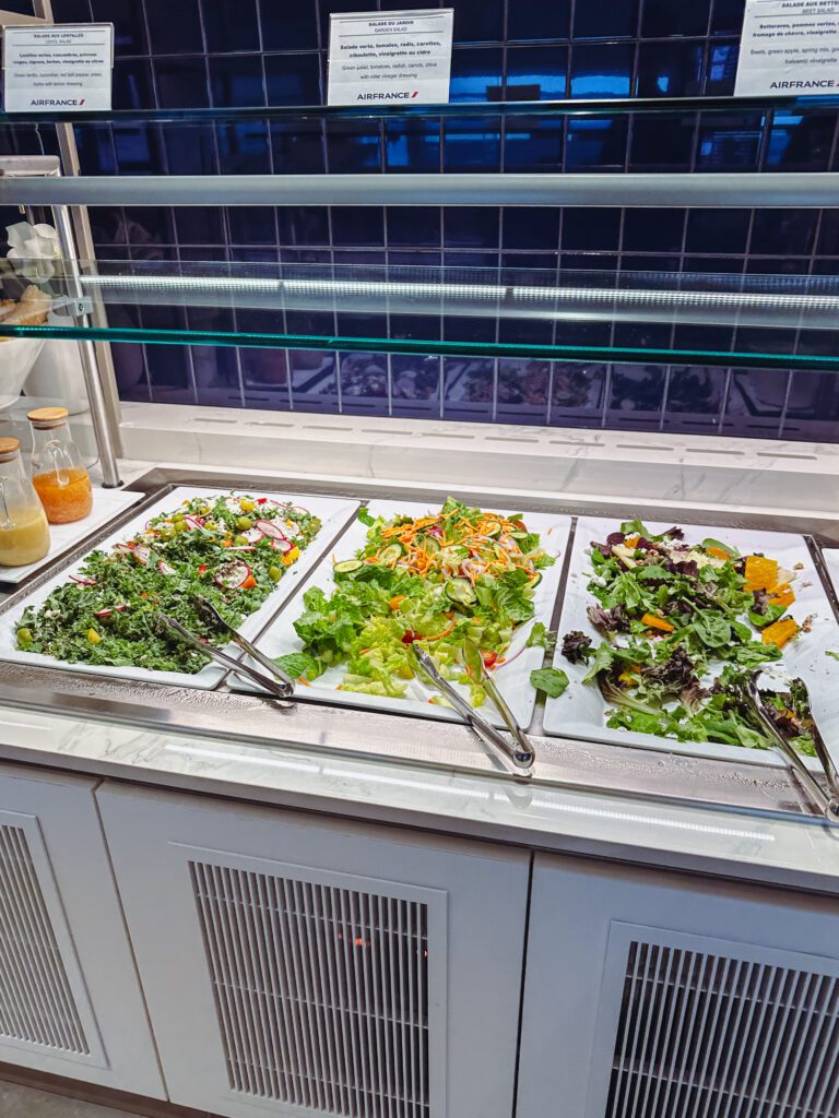a buffet with different salads on it