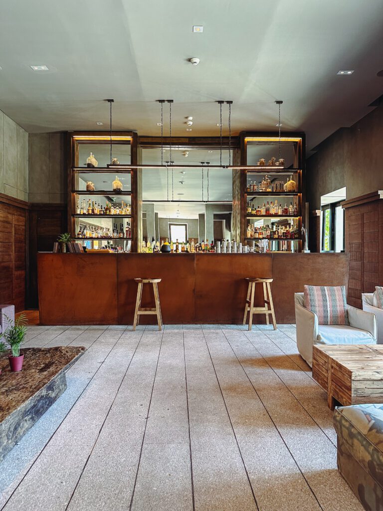 a bar with shelves and stools