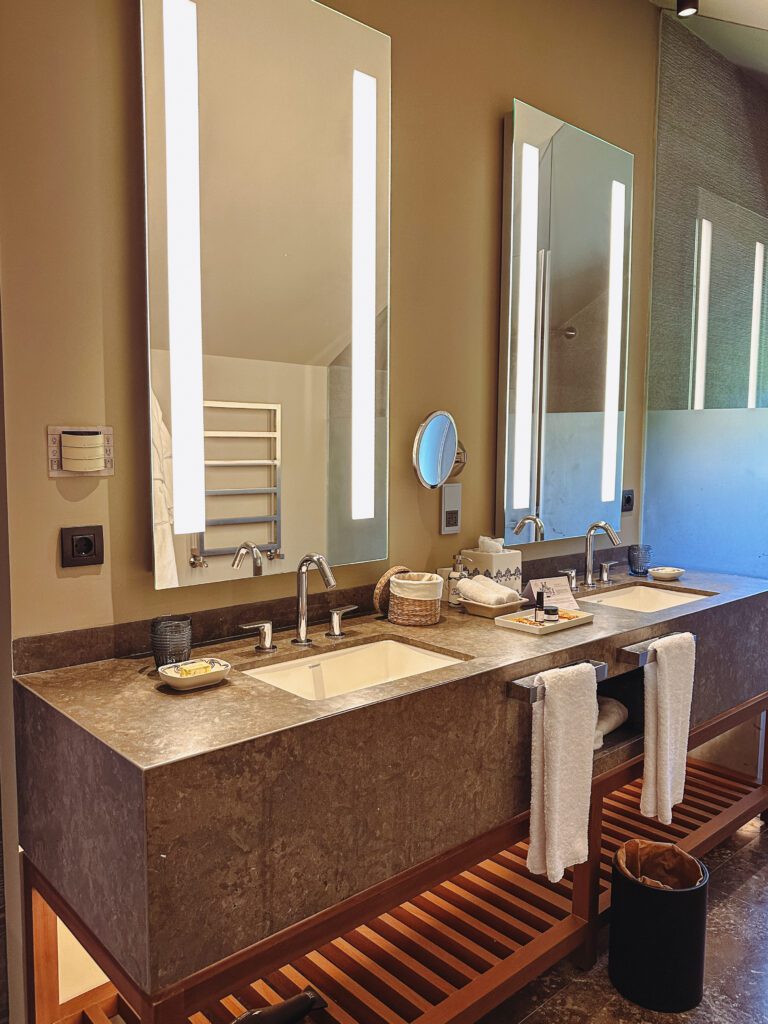 a bathroom with a large mirror and two sinks