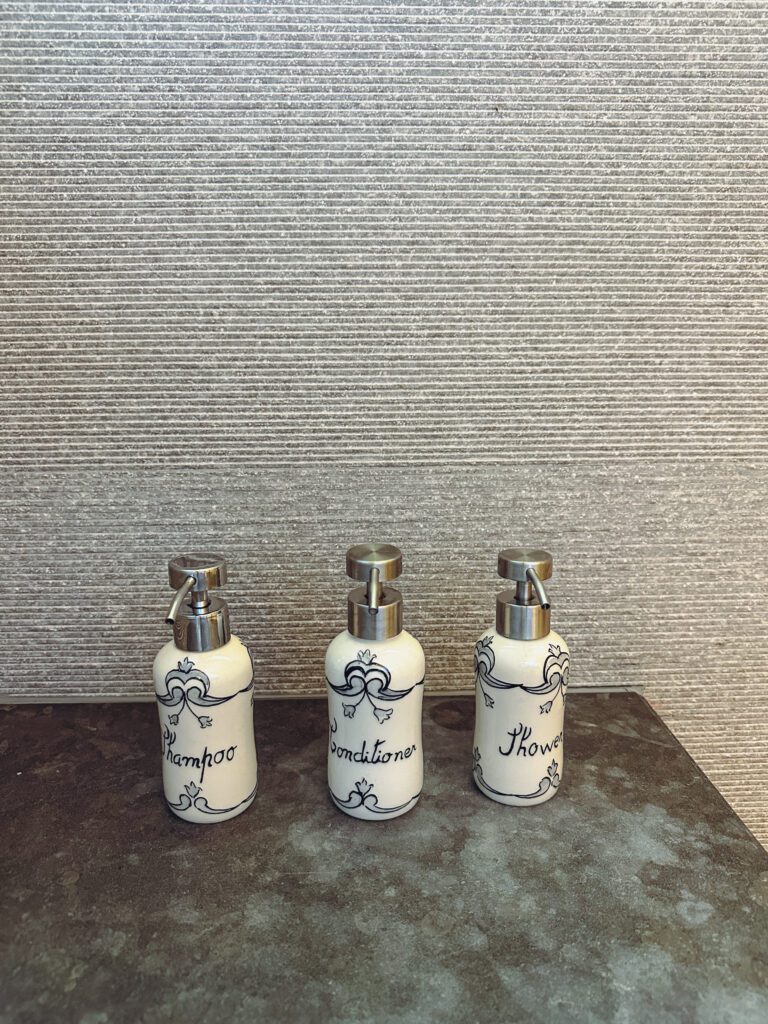 a group of white bottles with silver lids