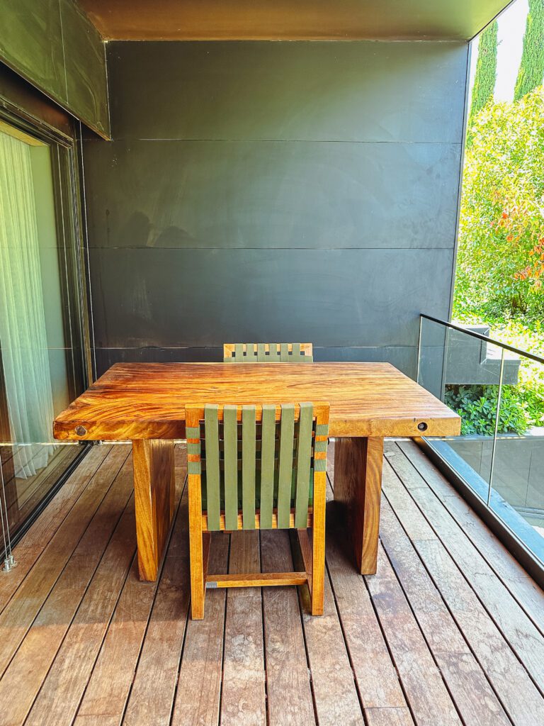 a table and chair on a deck