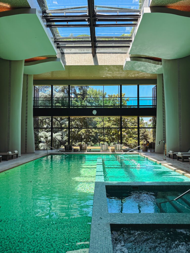 a indoor pool with a large glass roof