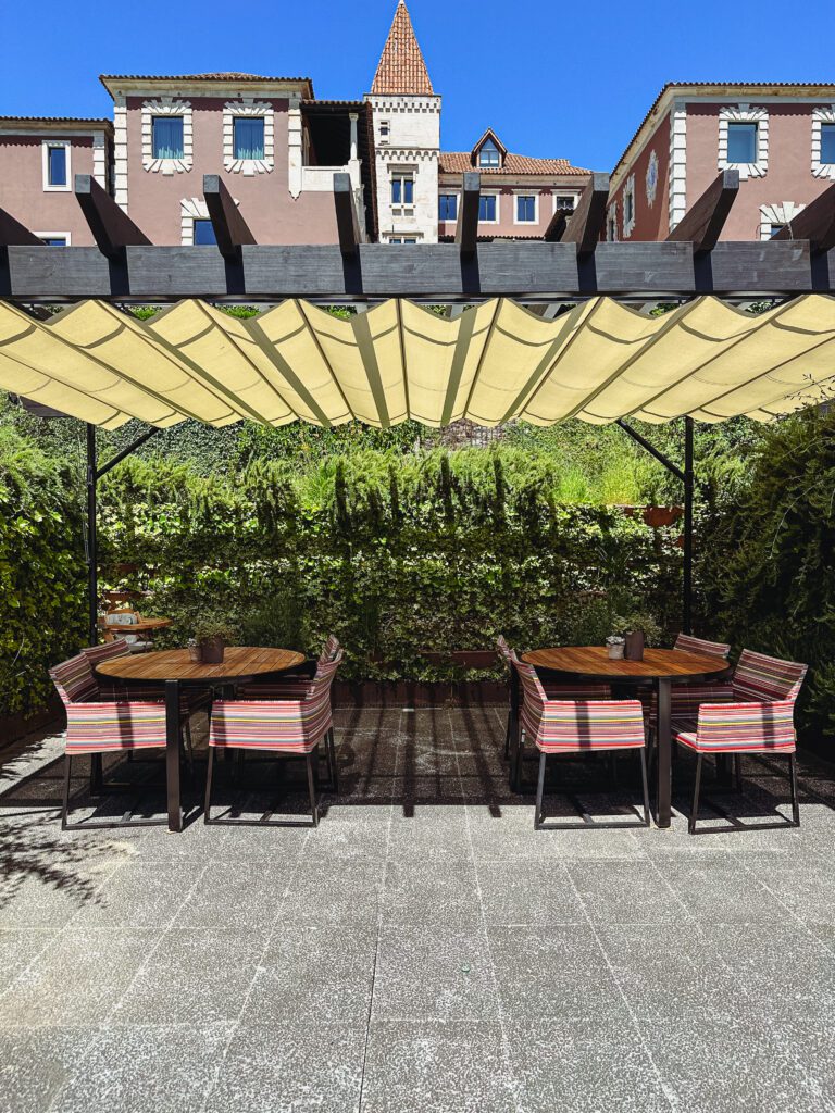 a table and chairs under a shade