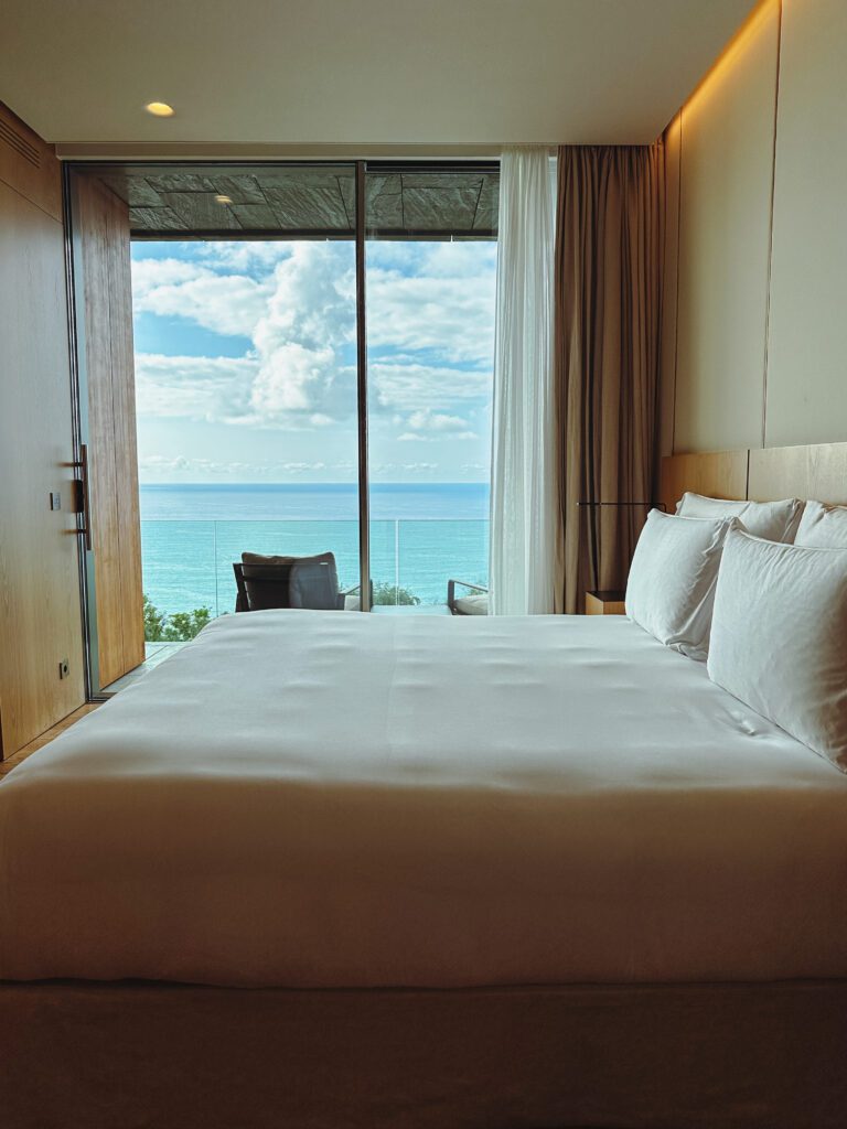 a bed with a view of the ocean