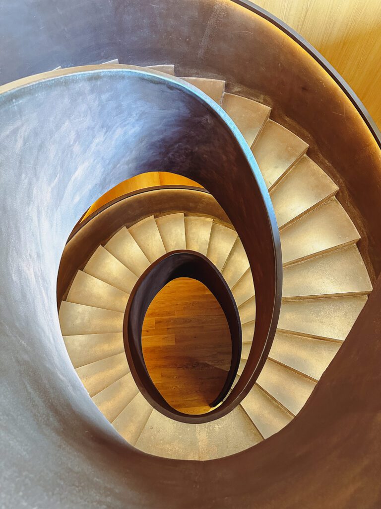 a spiral staircase with a wood floor